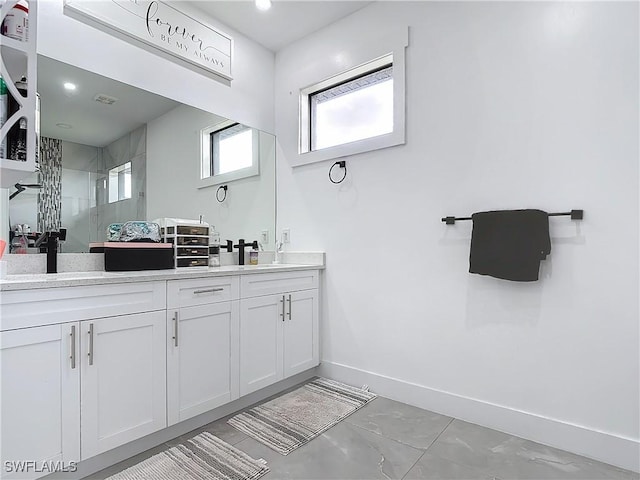 bathroom featuring vanity and a tile shower