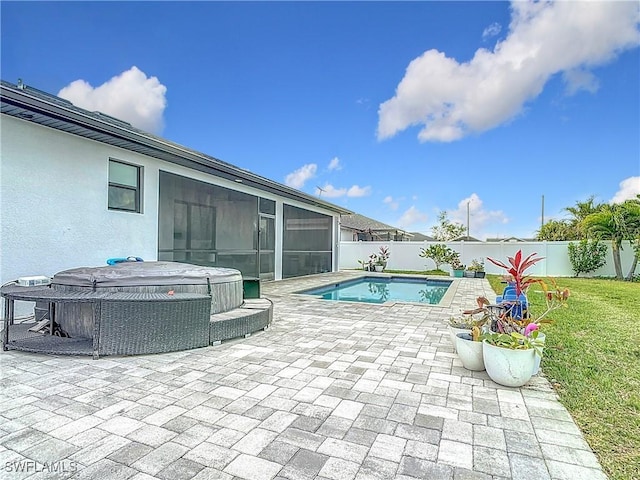 view of pool with a sunroom, a patio, and a hot tub