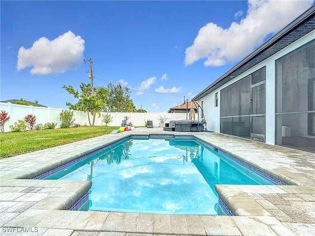 view of pool featuring a jacuzzi, a lawn, and a sunroom