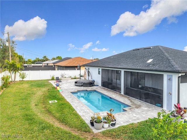 view of pool with a lawn, a patio area, a jacuzzi, and a sunroom