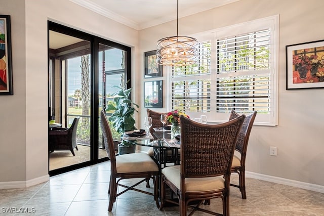 tiled dining space featuring crown molding and a chandelier