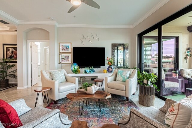 tiled living room featuring ceiling fan and crown molding