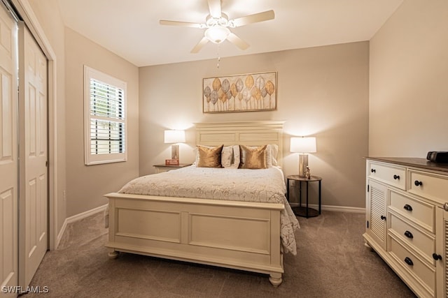 bedroom featuring dark colored carpet, a closet, and ceiling fan