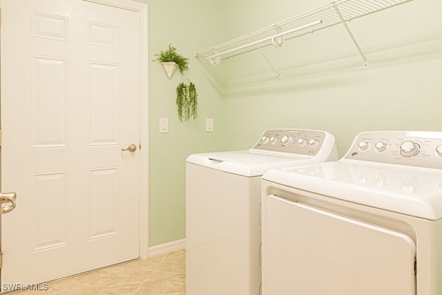 washroom featuring separate washer and dryer and light tile patterned floors