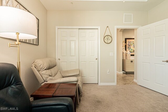 living area featuring light carpet