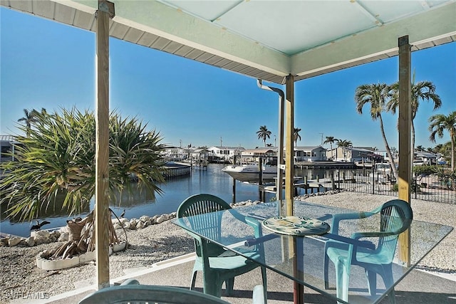 view of patio featuring a water view and a dock