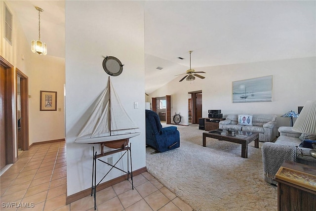 living room featuring ceiling fan with notable chandelier, light tile patterned flooring, and vaulted ceiling