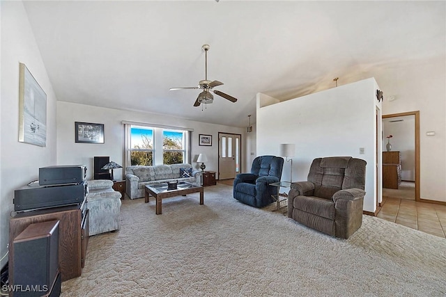 carpeted living room with ceiling fan and lofted ceiling