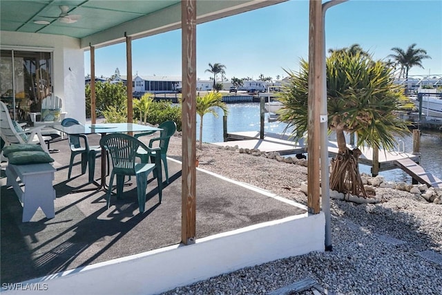 view of patio / terrace featuring a water view and ceiling fan