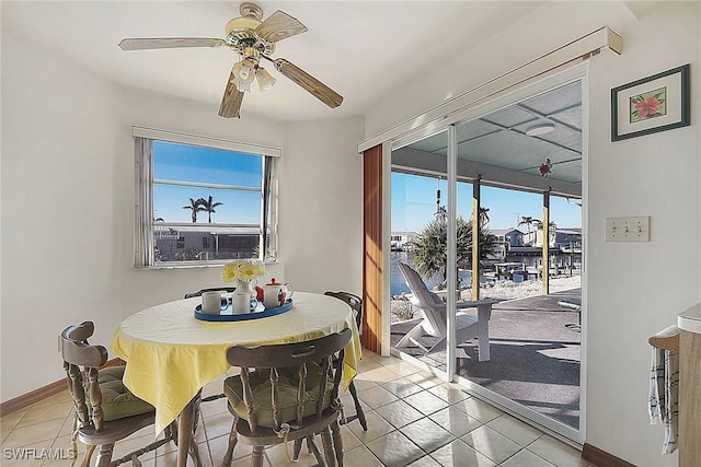 dining room with ceiling fan and light tile patterned flooring