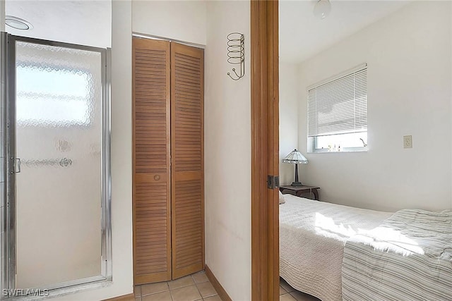 bedroom featuring a closet and light tile patterned flooring