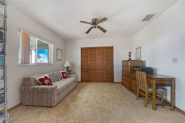 carpeted living room with ceiling fan