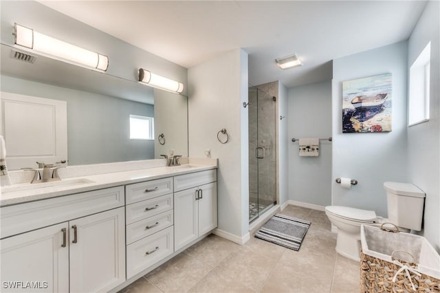 bathroom featuring vanity, a shower with shower door, and toilet