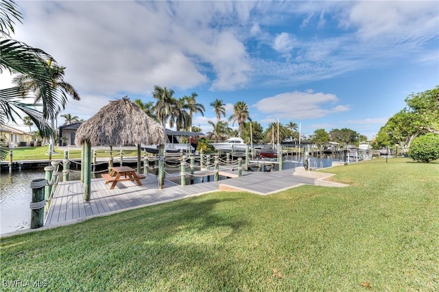 view of dock featuring a yard and a water view