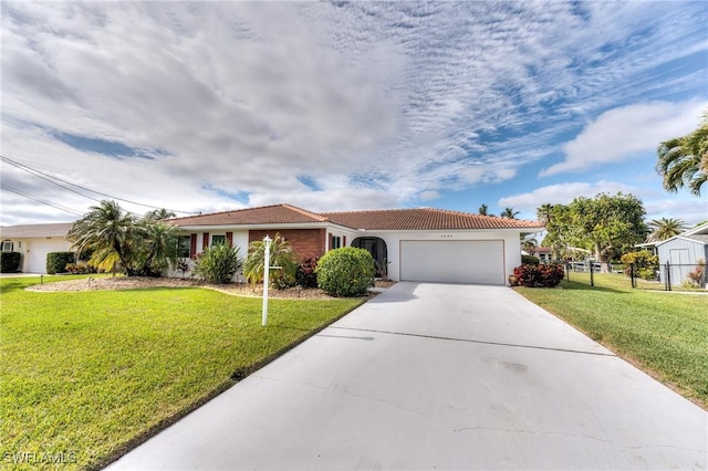 view of front of home featuring a garage and a front lawn