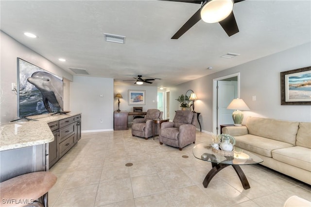 living room featuring ceiling fan and light tile patterned flooring