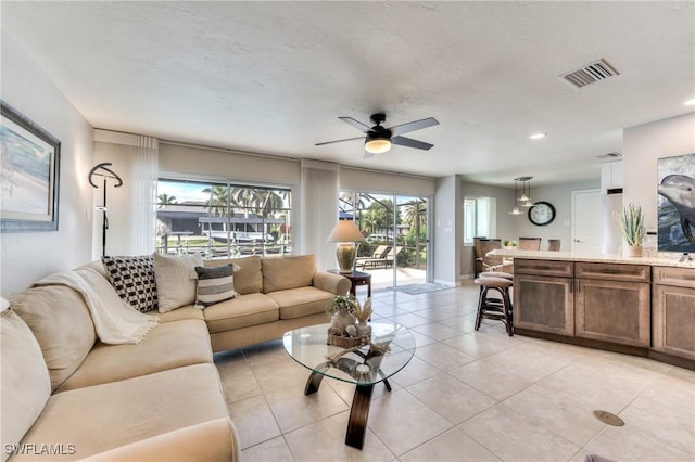 tiled living room with ceiling fan