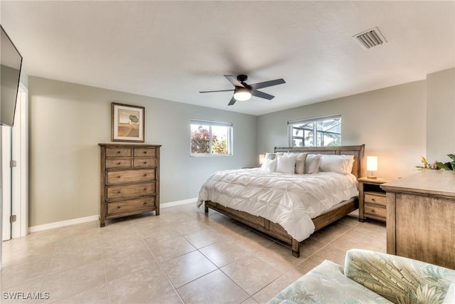 bedroom with ceiling fan and light tile patterned flooring