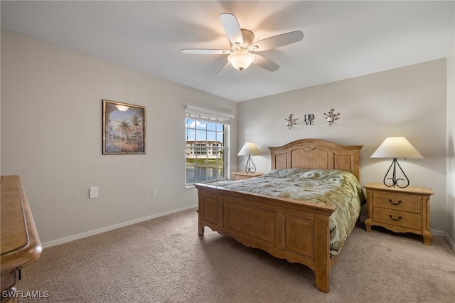 bedroom with ceiling fan and light colored carpet