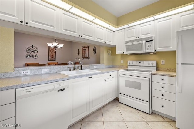 kitchen featuring white cabinetry, sink, and white appliances