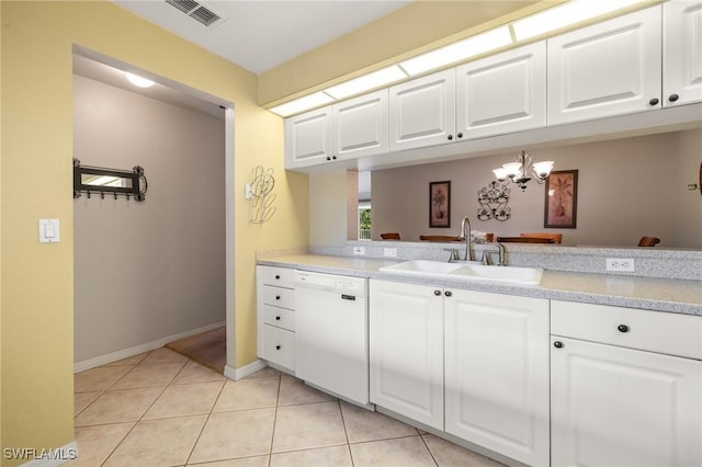 kitchen featuring white dishwasher, sink, white cabinets, and light tile patterned floors