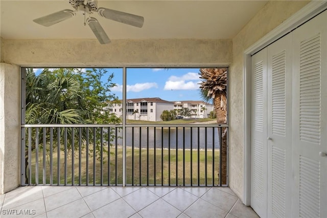 unfurnished sunroom with ceiling fan