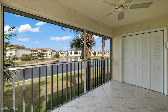 balcony with ceiling fan and a water view