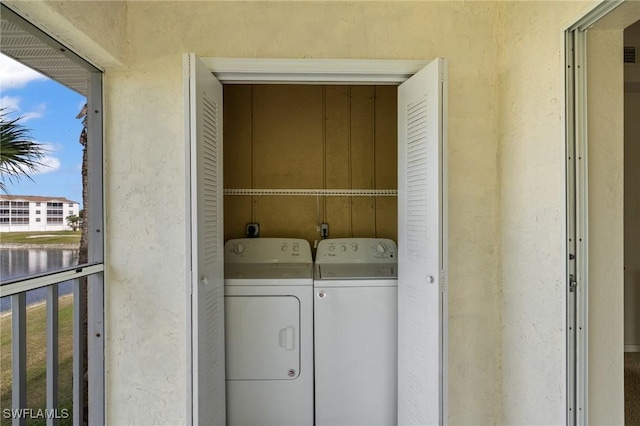 clothes washing area featuring washing machine and dryer