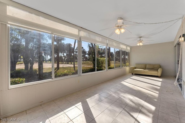 unfurnished sunroom featuring ceiling fan