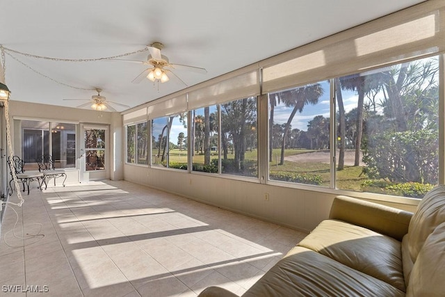 sunroom featuring ceiling fan and plenty of natural light