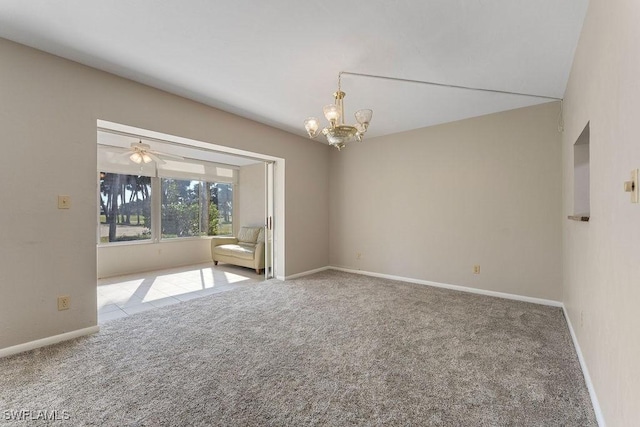 carpeted empty room with an inviting chandelier