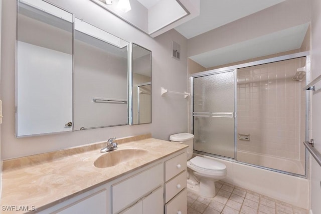 full bathroom with toilet, vanity, and bath / shower combo with glass door