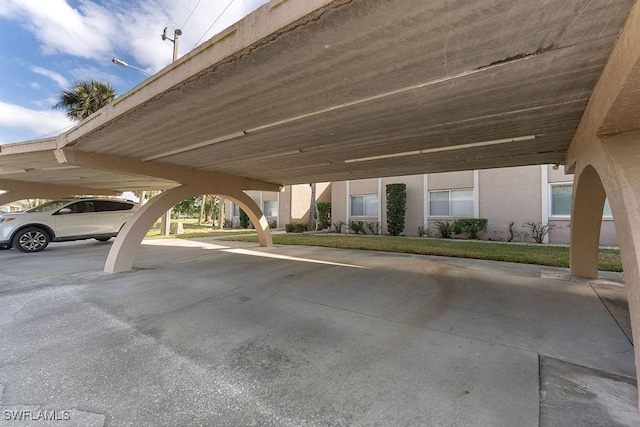 view of parking / parking lot featuring a carport