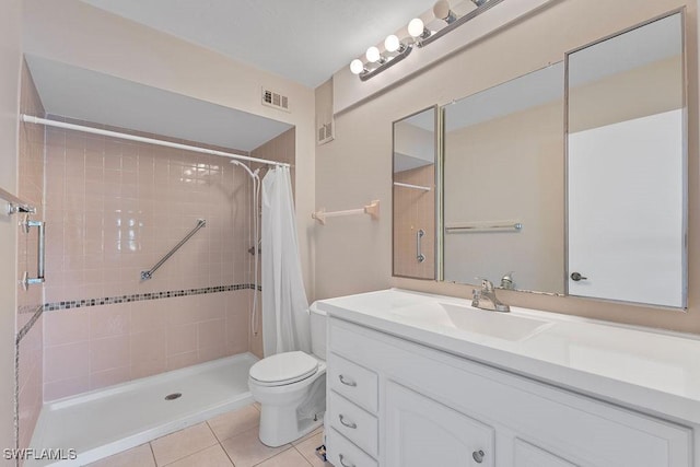 bathroom featuring toilet, vanity, tile patterned floors, and walk in shower