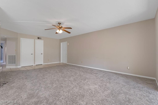 spare room featuring ceiling fan and light colored carpet