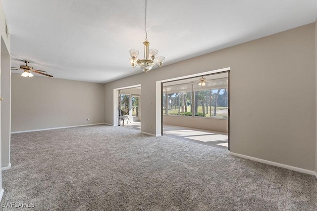 carpeted spare room featuring a chandelier