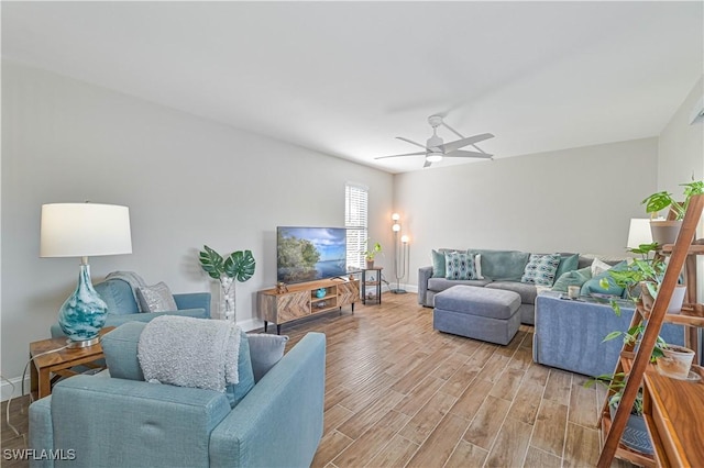 living room featuring light wood-type flooring and ceiling fan