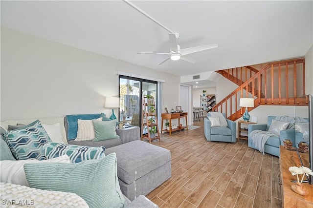 living room featuring wood-type flooring and ceiling fan