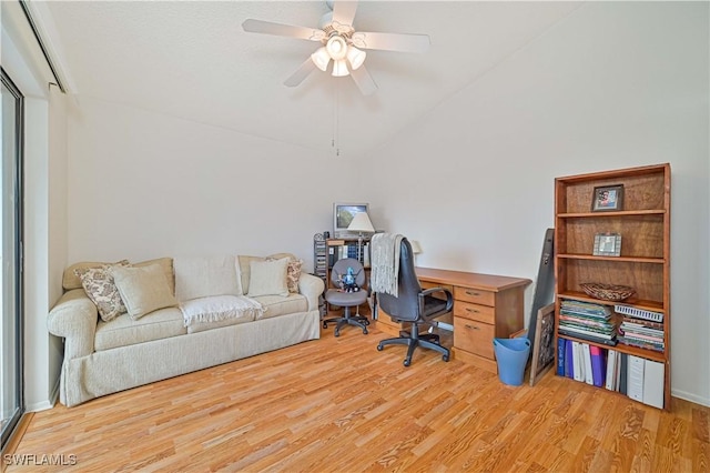 home office featuring ceiling fan, light hardwood / wood-style floors, and lofted ceiling