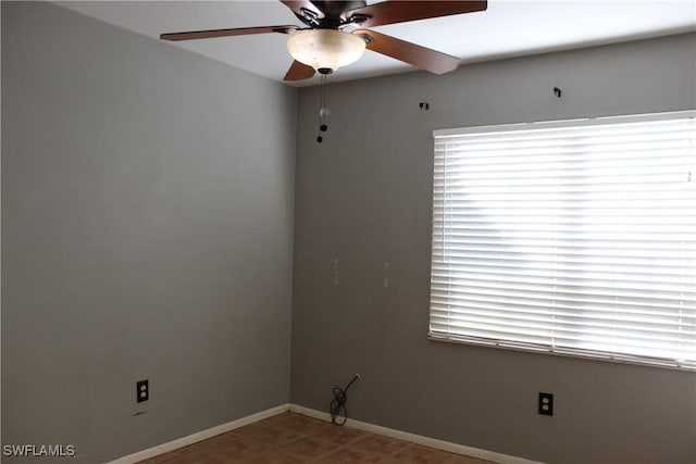 empty room featuring ceiling fan and a wealth of natural light