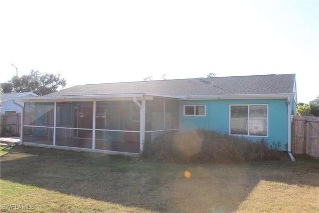 rear view of house featuring a lawn