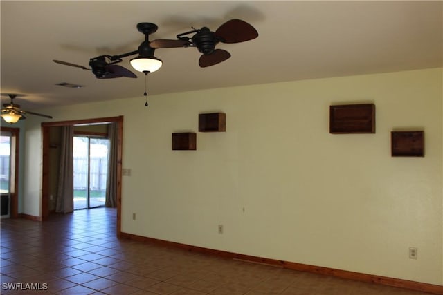 empty room featuring ceiling fan and tile patterned flooring