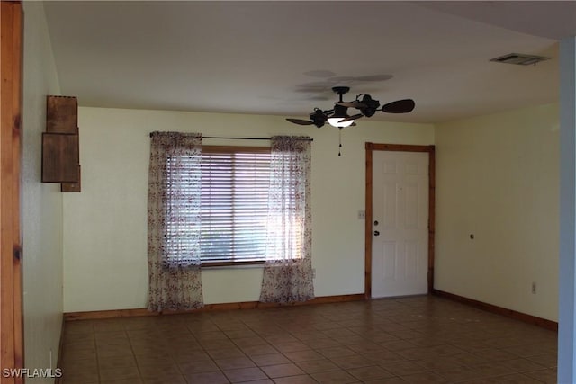 spare room featuring ceiling fan and tile patterned floors