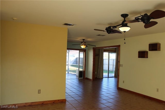 tiled empty room with ceiling fan