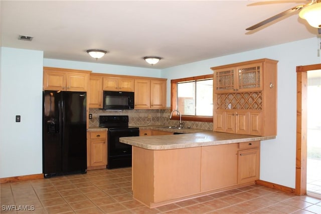 kitchen featuring black appliances, kitchen peninsula, ceiling fan, sink, and tasteful backsplash