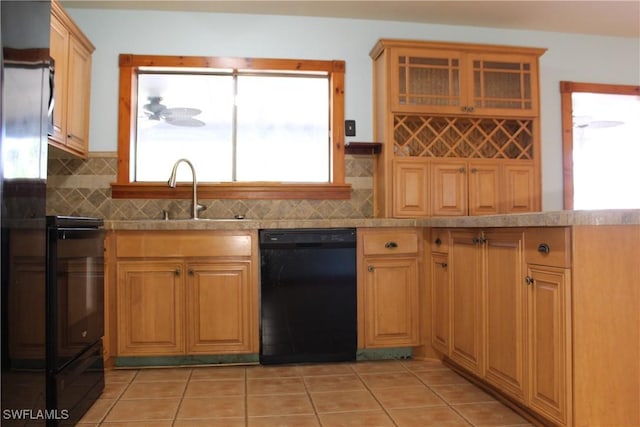 kitchen featuring dishwasher, light tile patterned floors, and sink