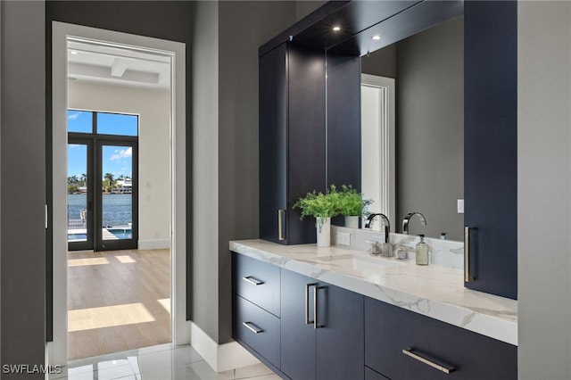 bathroom featuring vanity, baseboards, and wood finished floors