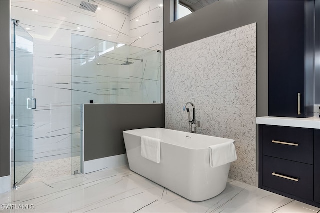 bathroom with marble finish floor, a marble finish shower, and a soaking tub