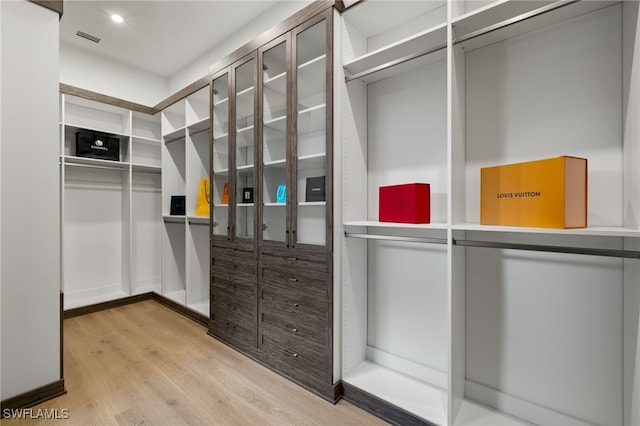 walk in closet with visible vents and wood finished floors