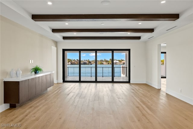 unfurnished room featuring recessed lighting, visible vents, light wood-style floors, beamed ceiling, and baseboards